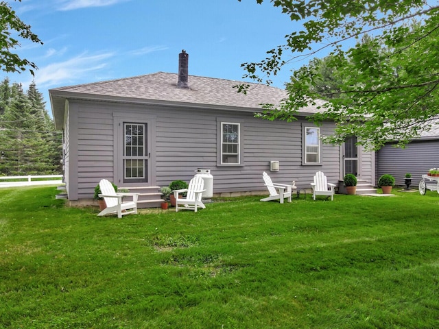 back of house with a lawn