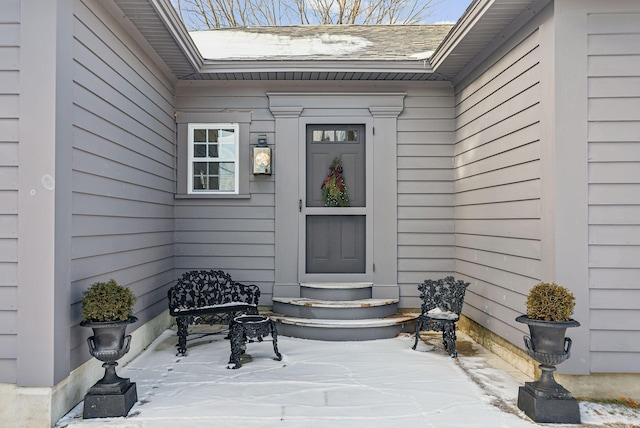 view of exterior entry featuring a patio area