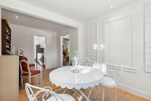 dining area with hardwood / wood-style floors