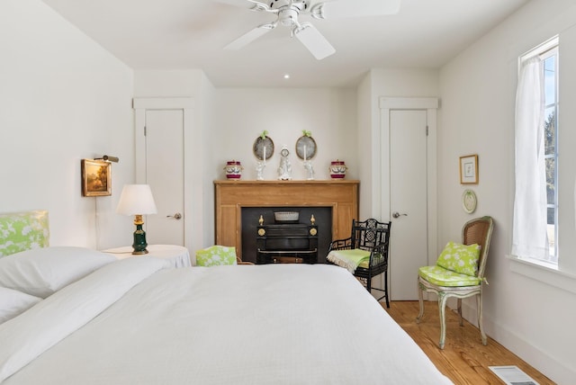 bedroom featuring ceiling fan and light hardwood / wood-style flooring