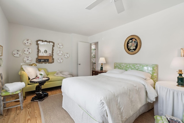 bedroom with ceiling fan and hardwood / wood-style flooring