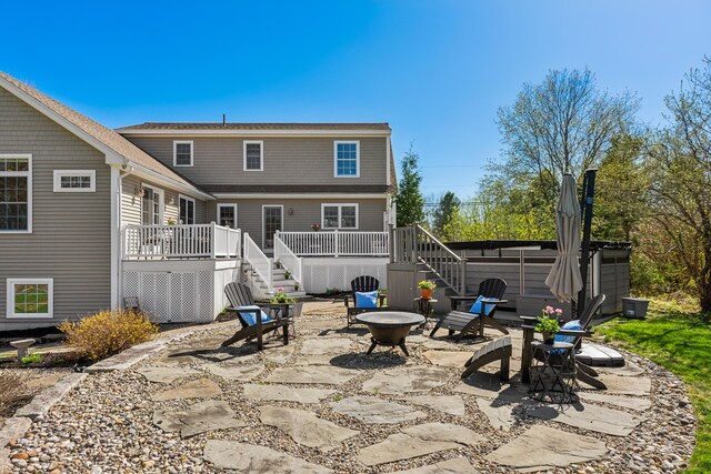 back of house featuring a patio, a fire pit, stairway, and a deck