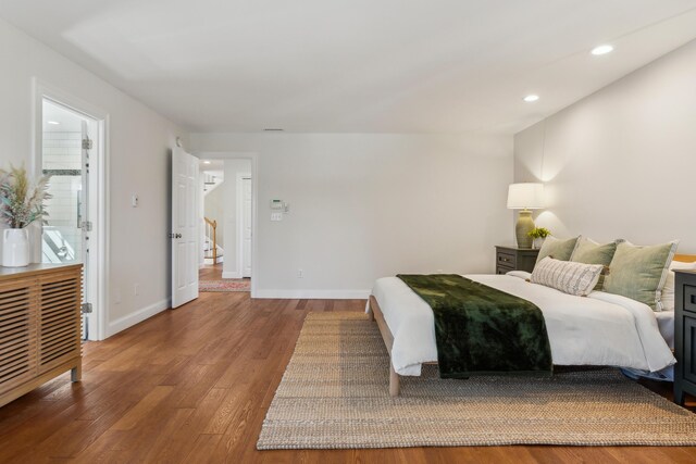 bedroom with recessed lighting, baseboards, and wood finished floors