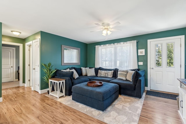 living room with ceiling fan, light hardwood / wood-style flooring, and a healthy amount of sunlight