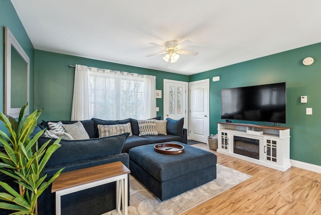 living room with ceiling fan and hardwood / wood-style floors