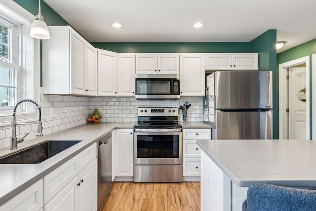 kitchen featuring white cabinets, appliances with stainless steel finishes, and sink