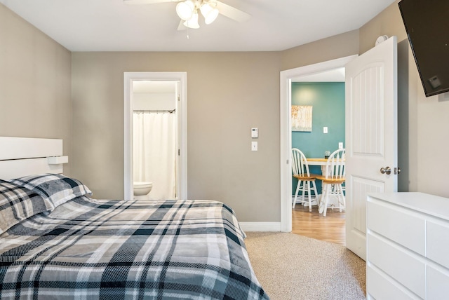 carpeted bedroom with ceiling fan and connected bathroom