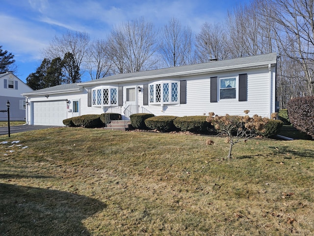 single story home featuring a garage and a front lawn