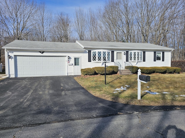 single story home with a front yard and a garage