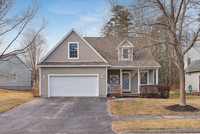 cape cod-style house featuring covered porch, a front yard, and a garage