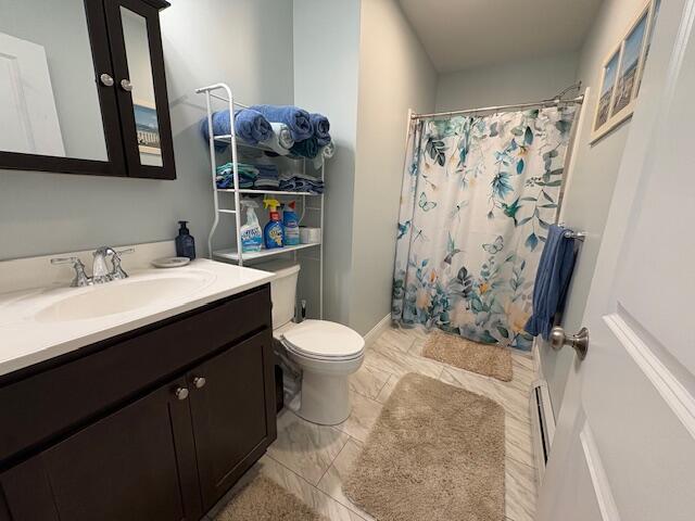 bathroom with tile patterned floors, vanity, a shower with shower curtain, and toilet