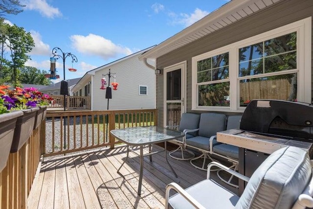 deck with grilling area and an outdoor hangout area