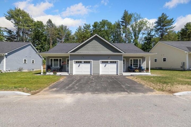 view of front of house featuring a garage, a porch, and a front yard