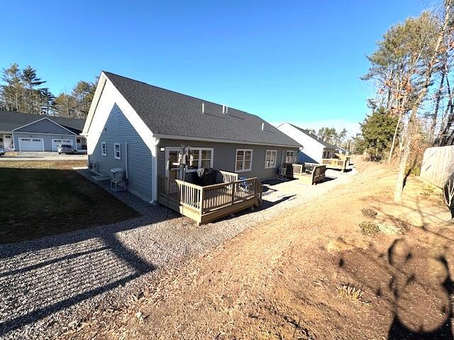 back of house with a wooden deck