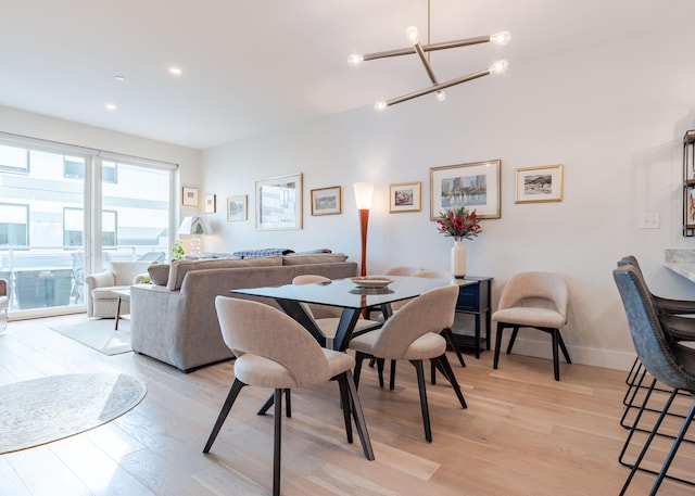 dining room featuring light hardwood / wood-style floors and a notable chandelier