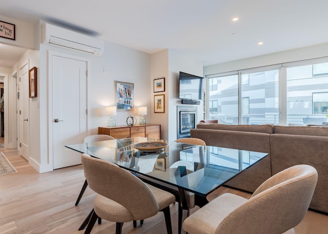 dining room featuring light hardwood / wood-style flooring and a wall mounted AC