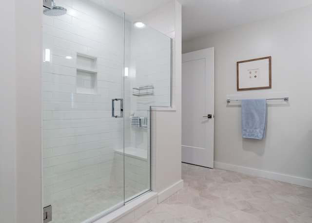 bathroom with a shower with door