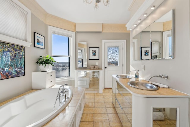 bathroom featuring a relaxing tiled tub and sink