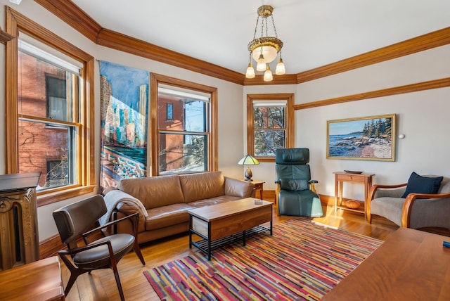 living room with light hardwood / wood-style flooring and ornamental molding