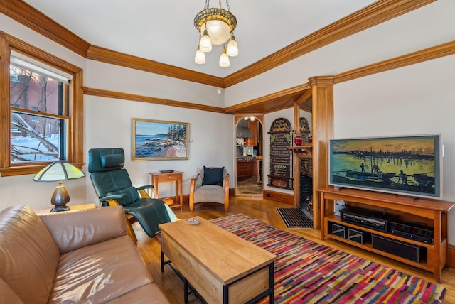 living room featuring crown molding and hardwood / wood-style floors