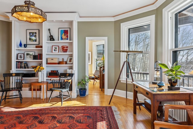 sitting room featuring crown molding and light wood-type flooring