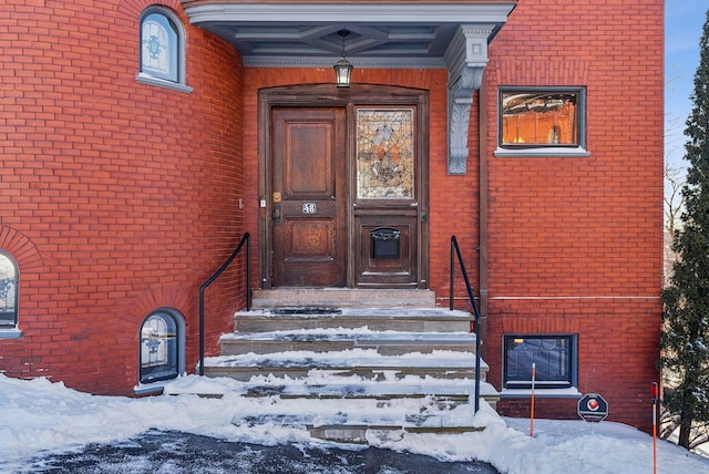 view of snow covered property entrance