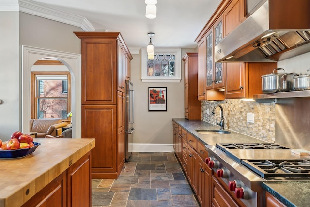 kitchen featuring crown molding, sink, range, range hood, and wood counters