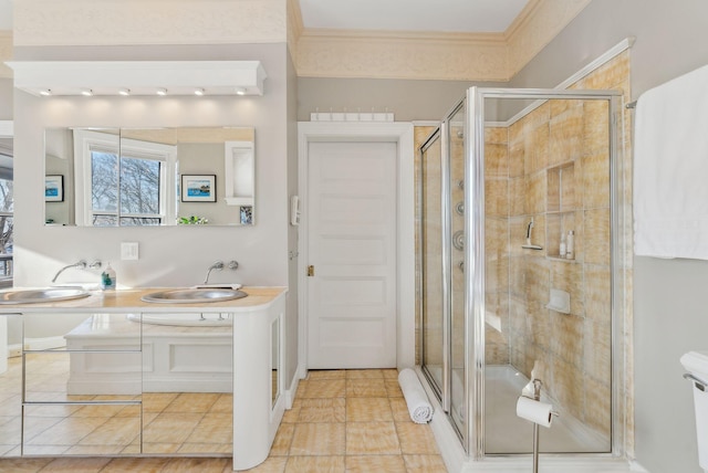 bathroom featuring ornamental molding, tile patterned flooring, a shower with shower door, and vanity