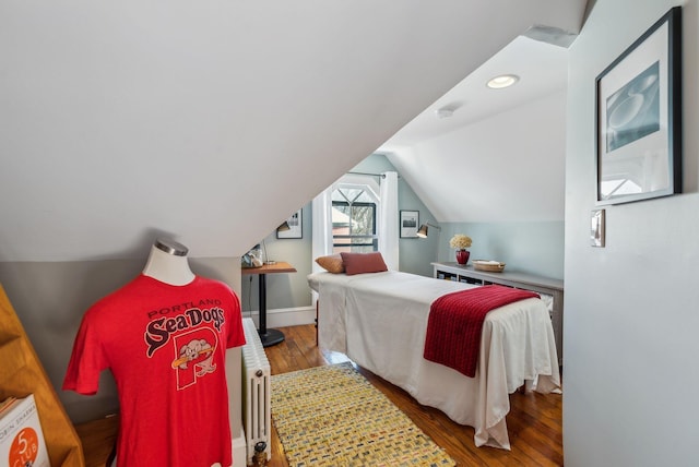 bedroom featuring vaulted ceiling and wood-type flooring