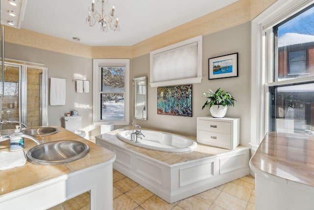 bathroom with sink, tile patterned floors, a bathing tub, and a chandelier