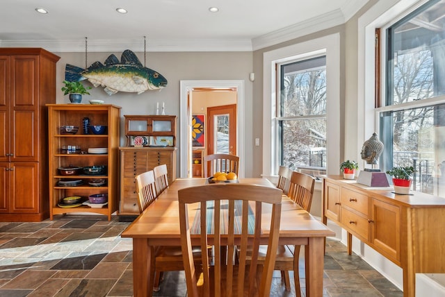 dining space with ornamental molding