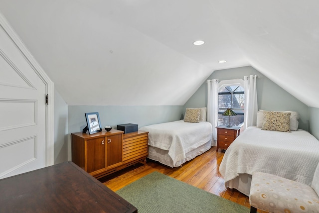 bedroom with wood-type flooring and lofted ceiling