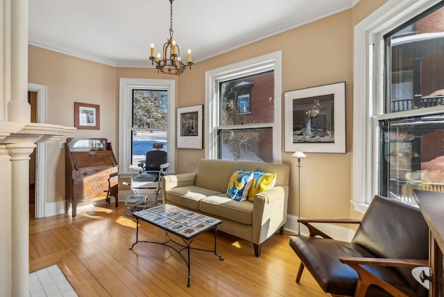 living area featuring crown molding, light wood-type flooring, and a notable chandelier