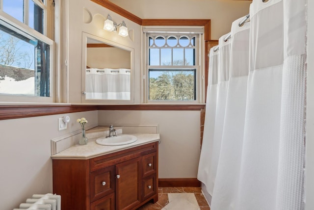 bathroom featuring vanity, radiator heating unit, and tile patterned floors