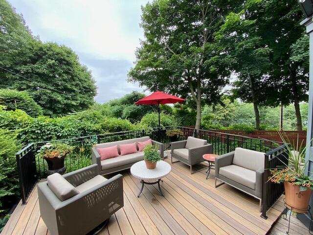 wooden terrace featuring outdoor lounge area