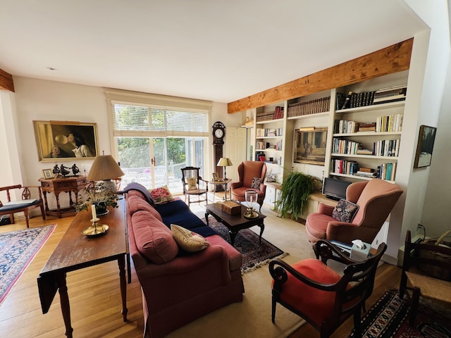 living room featuring beamed ceiling and hardwood / wood-style flooring