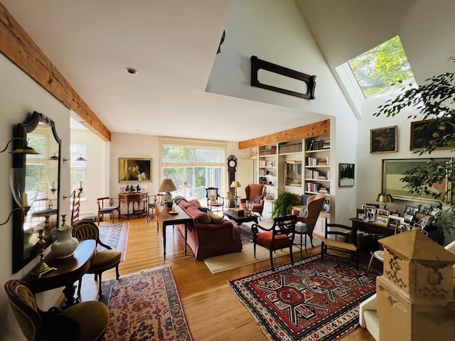 living room with light hardwood / wood-style floors and a skylight