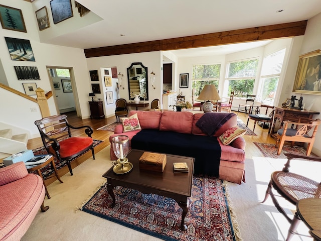 living room featuring light hardwood / wood-style flooring and beamed ceiling