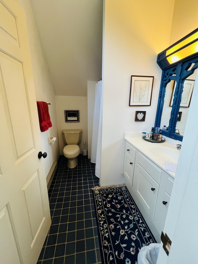 bathroom featuring tile patterned flooring, vanity, and toilet