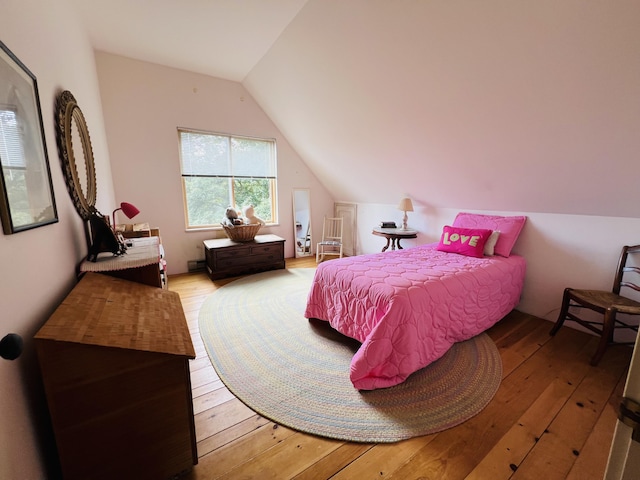 bedroom featuring lofted ceiling and light wood-type flooring