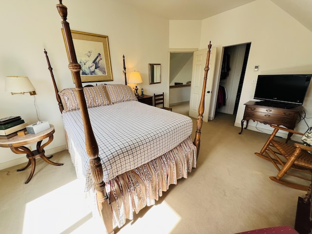 carpeted bedroom with lofted ceiling