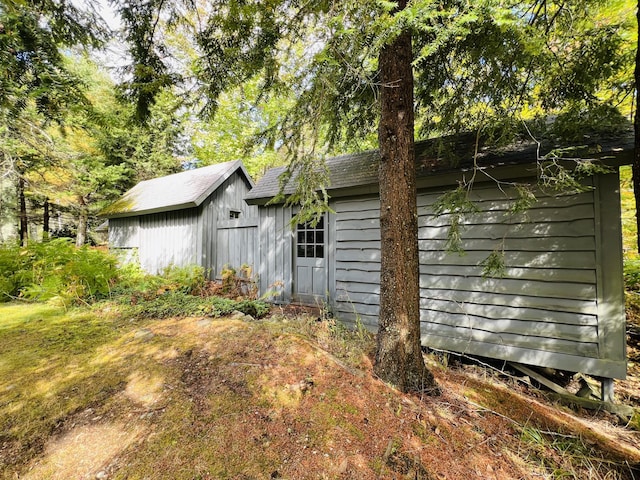 view of home's exterior with a storage shed