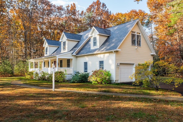 cape cod-style house with a garage, a porch, and a front lawn