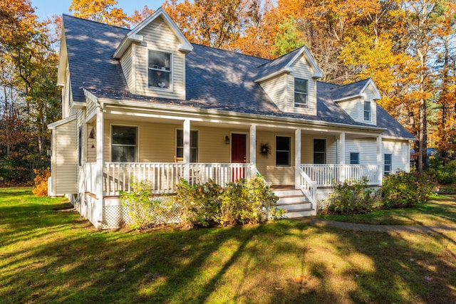 cape cod house featuring a front yard and covered porch