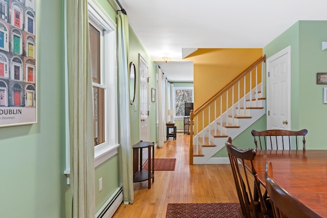 foyer with a baseboard radiator and light hardwood / wood-style flooring