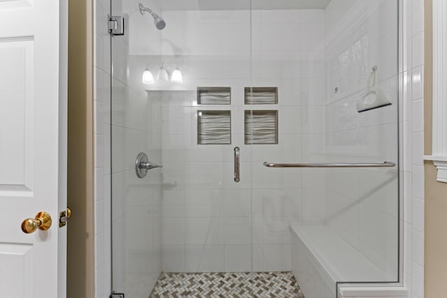 bathroom with a shower with door