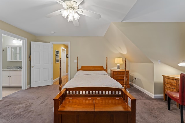 carpeted bedroom with lofted ceiling, connected bathroom, and ceiling fan