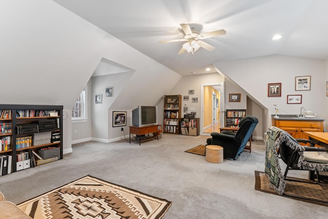 home office featuring vaulted ceiling, ceiling fan, and carpet