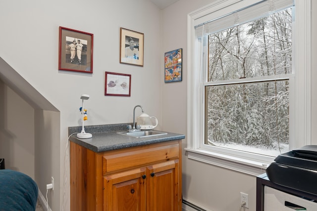 bathroom featuring a baseboard heating unit and sink