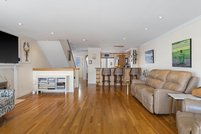 living room featuring hardwood / wood-style flooring and ornamental molding